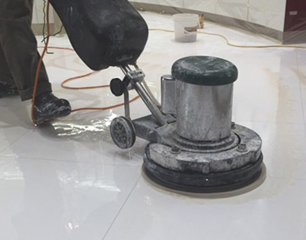cleaning the floor using power scrubber