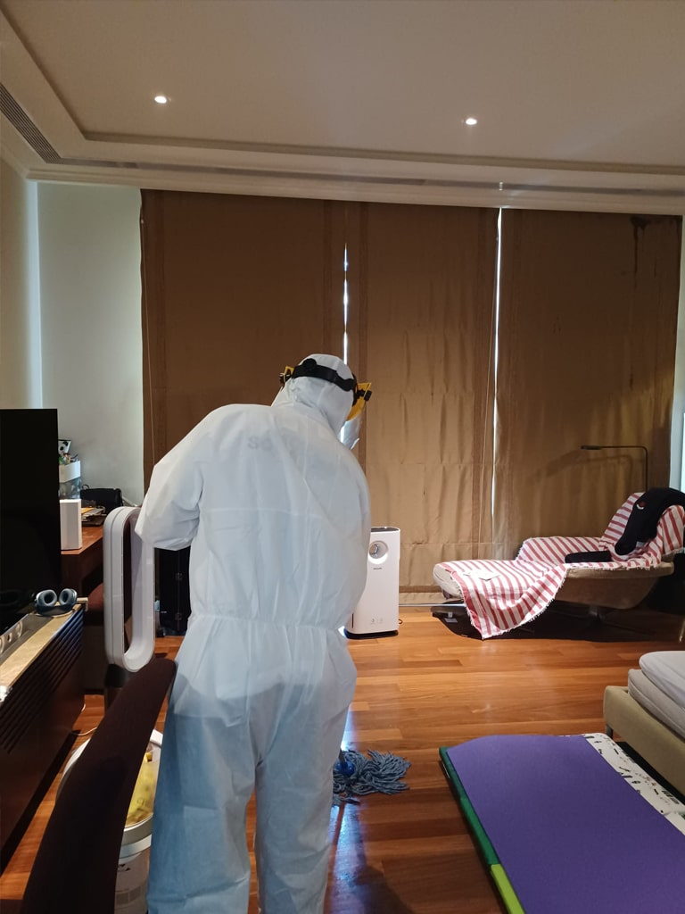 the guy using a mop to deep clean the floor