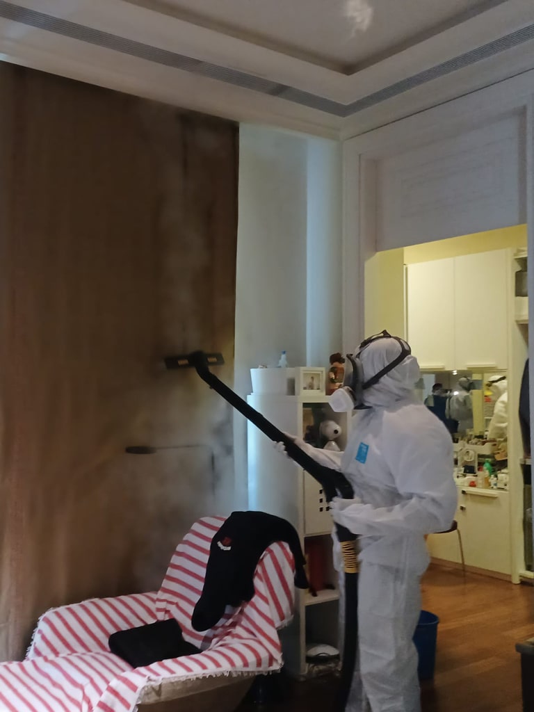 guy is deeep cleaning the room